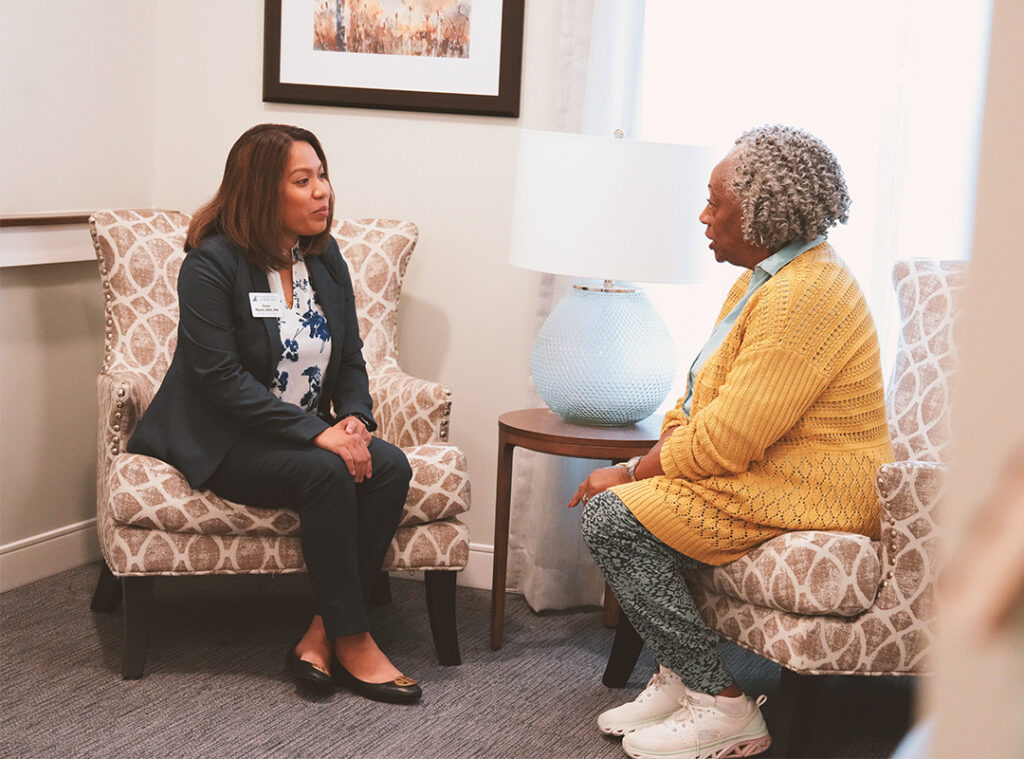 Benchmark associate speaking to a resident.